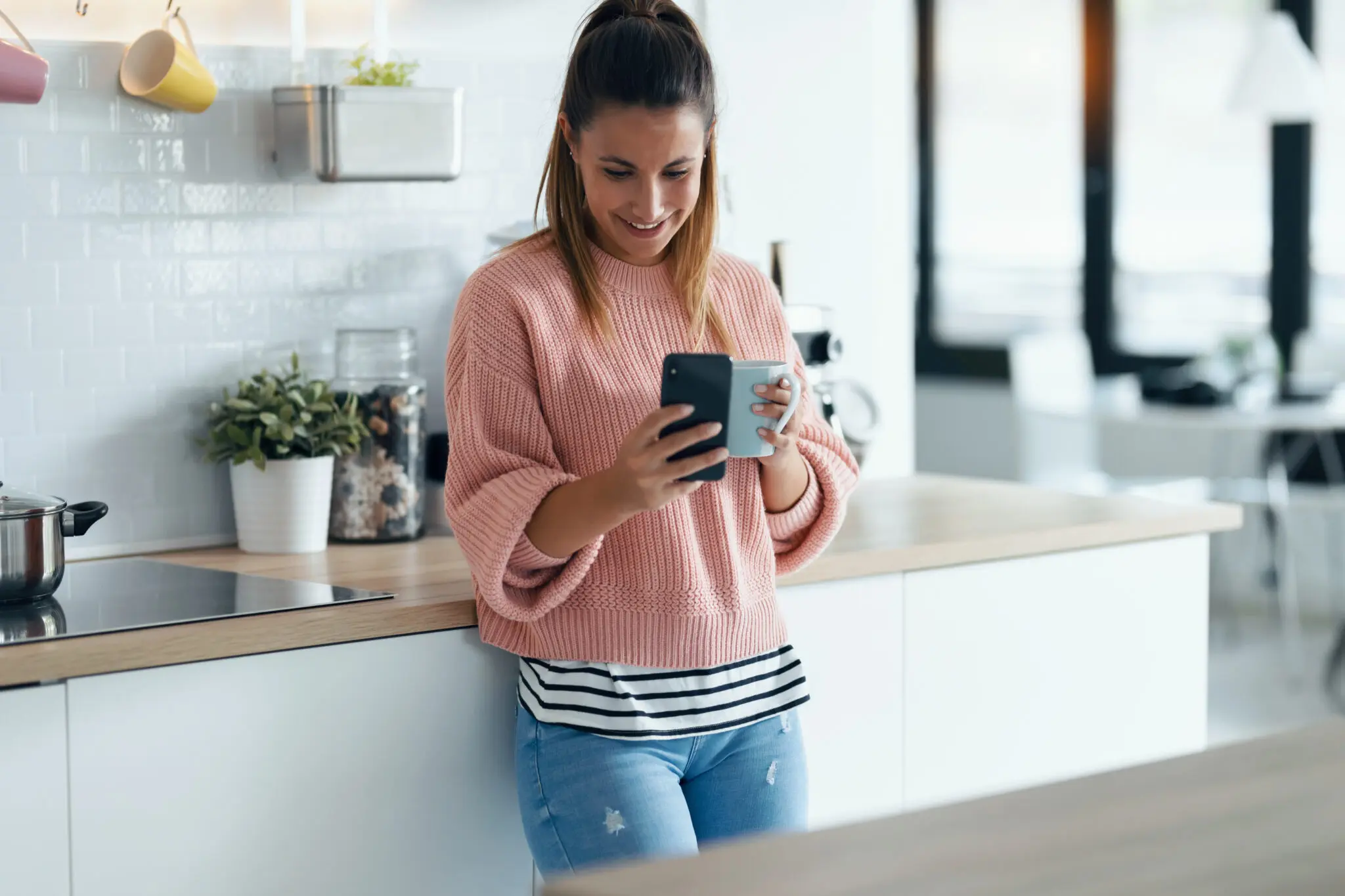 Renter with phone in temporary accommodation with kitchen facilities for insurance claims