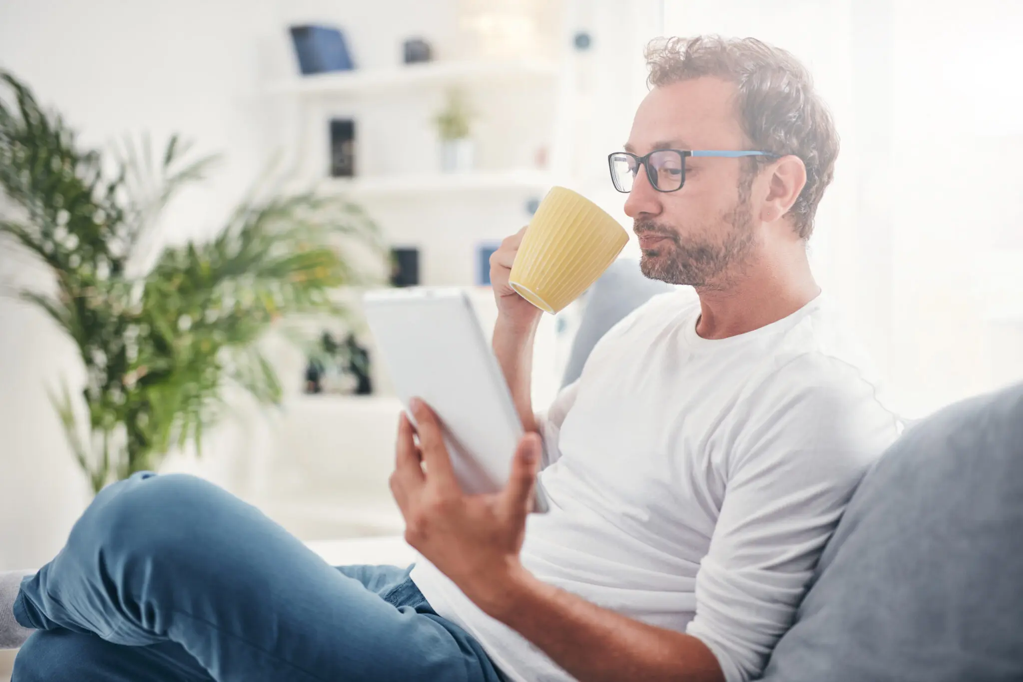 Man relaxing on sofa in Long-term serviced apartment for loss adjuster accommodation needs