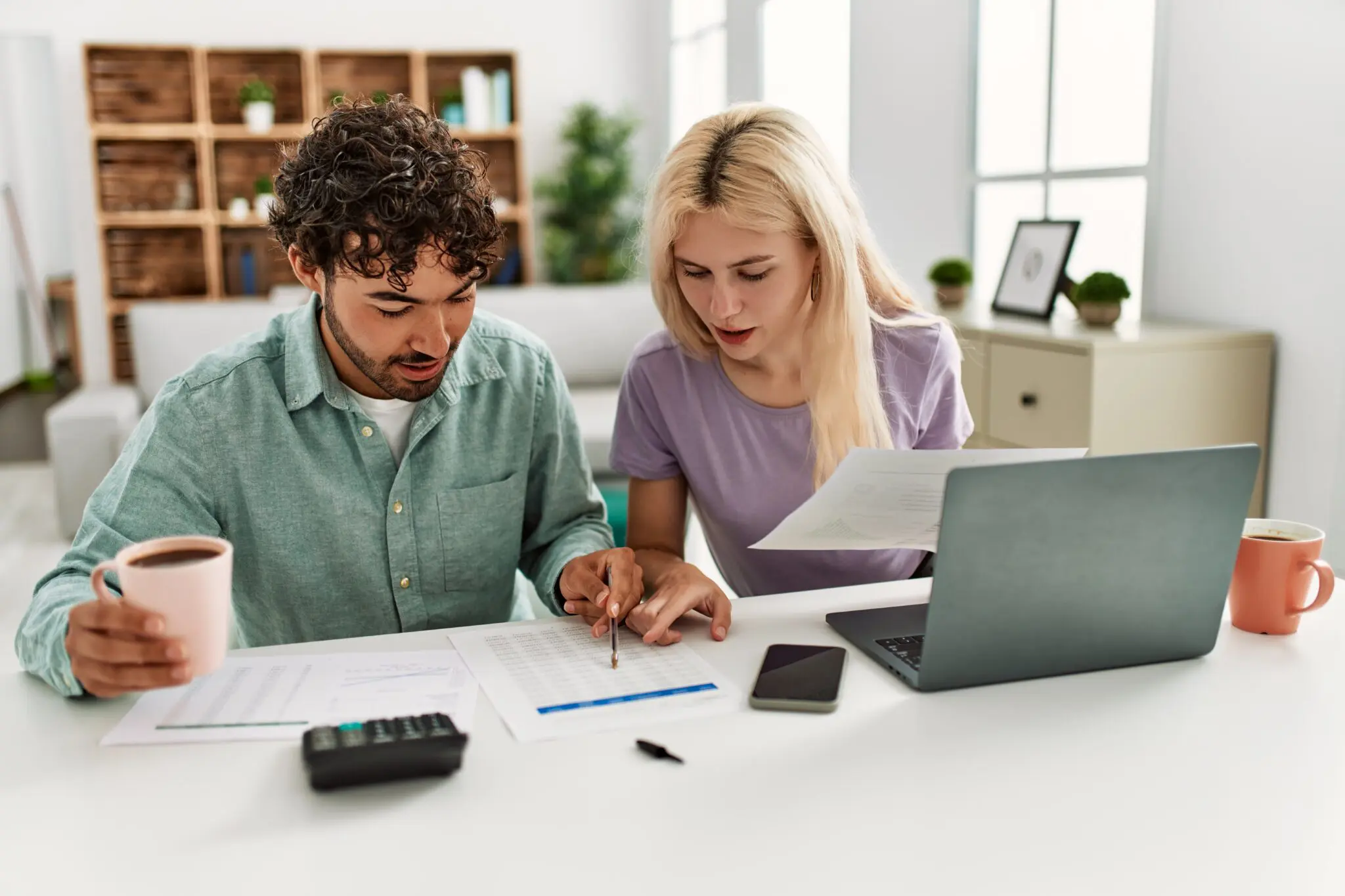 Young couple researching alternative accommodation for policyholders after property damage