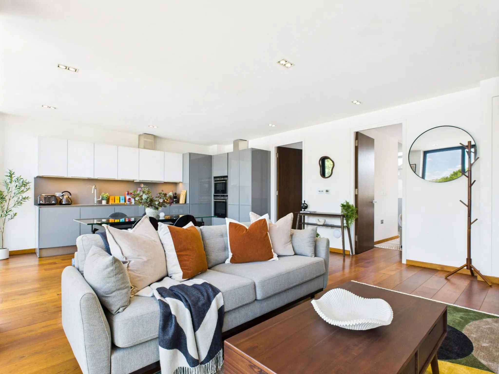 Open plan kitchen and living room with sofa in Corporate Housing options for Insurance Claims in the UK