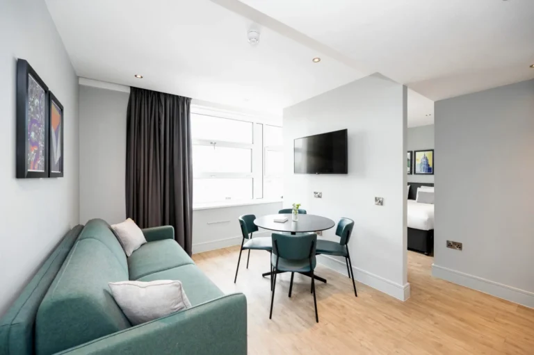 Smart living and dining area with adjoining bedroom in an affordable serviced apartment at Staycity Greenwich