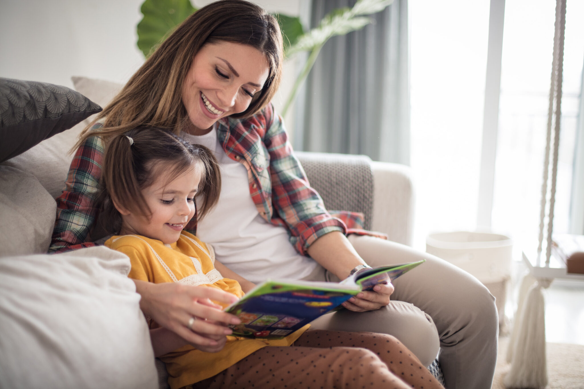Mother and daughter on the sofa in a serviced apartment for insurance temporary accommodation
